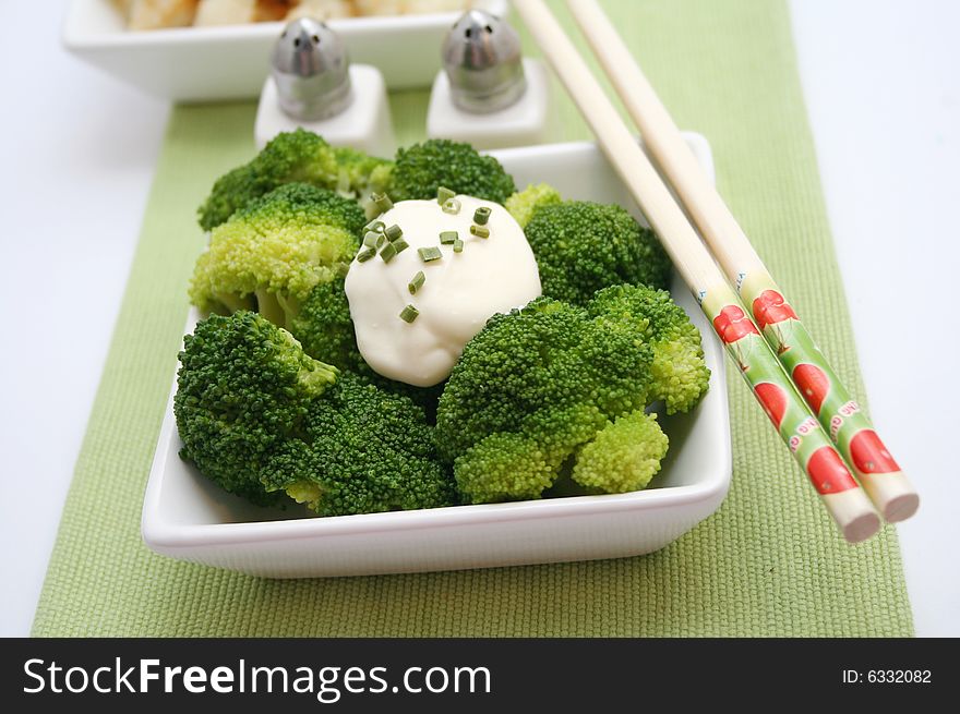 A meal of fresh broccoli with some cream