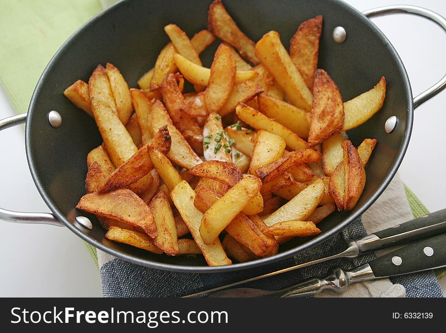 Some fresh potatoes slices in a pan. Some fresh potatoes slices in a pan
