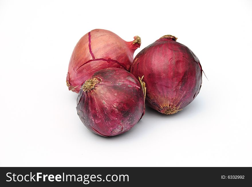 Shot of some red onions on white background