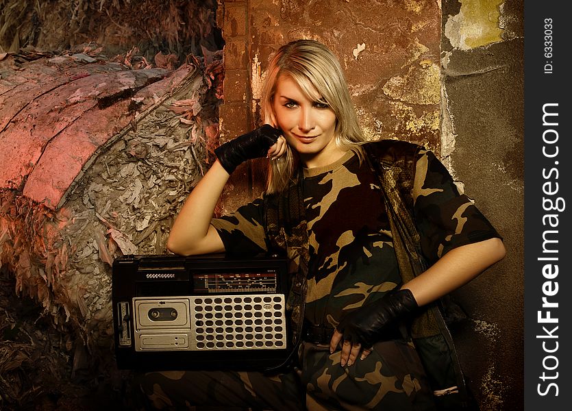 Beautiful female soldier with a retro music player