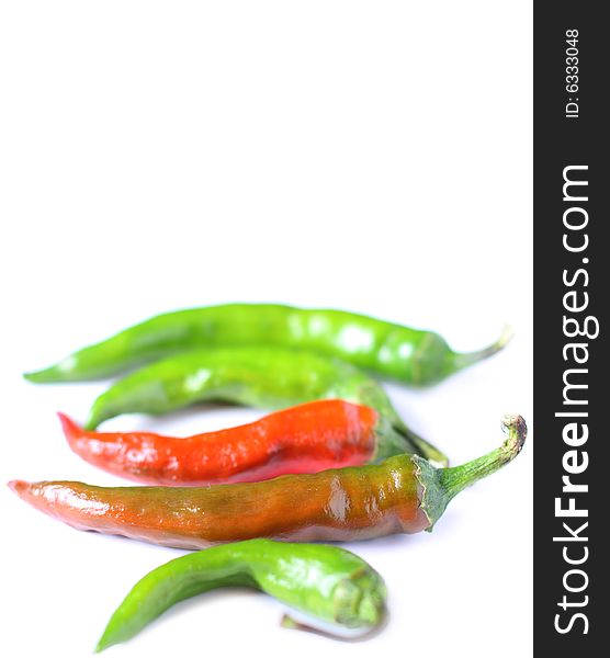 Chili peppers isolated on white background. Shot with shallow depth of field. Chili peppers isolated on white background. Shot with shallow depth of field
