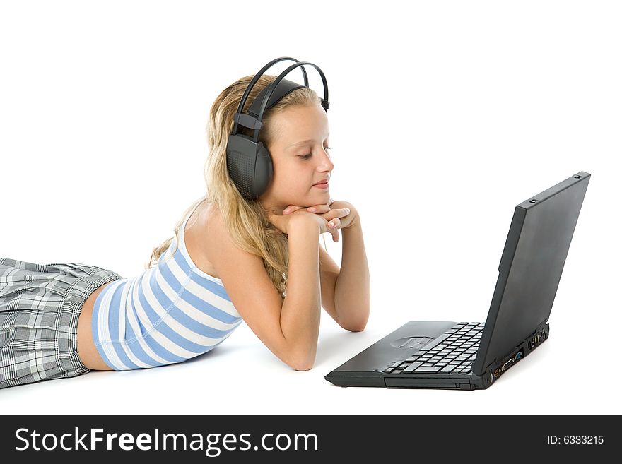 Teen girl on laptop with earphones