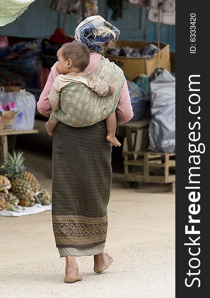 Asia, old woman with grandchild in a village of Laos