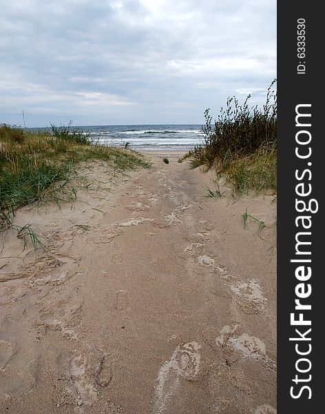 Human footprints on the wet sand on a rainy day. Human footprints on the wet sand on a rainy day.