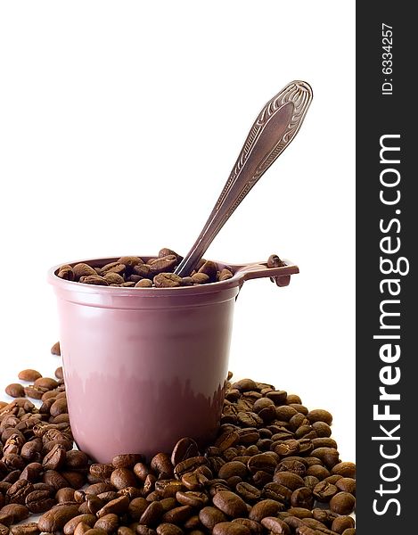 Cup with spoon and coffee beans on white