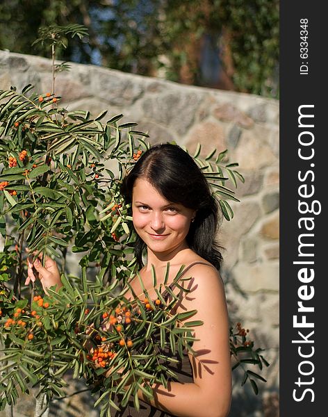 A young woman on holiday in the village. photo against a backdrop of mountain ash. A young woman on holiday in the village. photo against a backdrop of mountain ash.