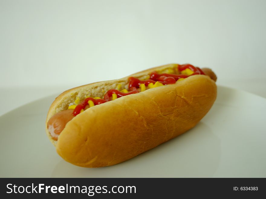 A close up view of a hotdog with ketchup and mustard