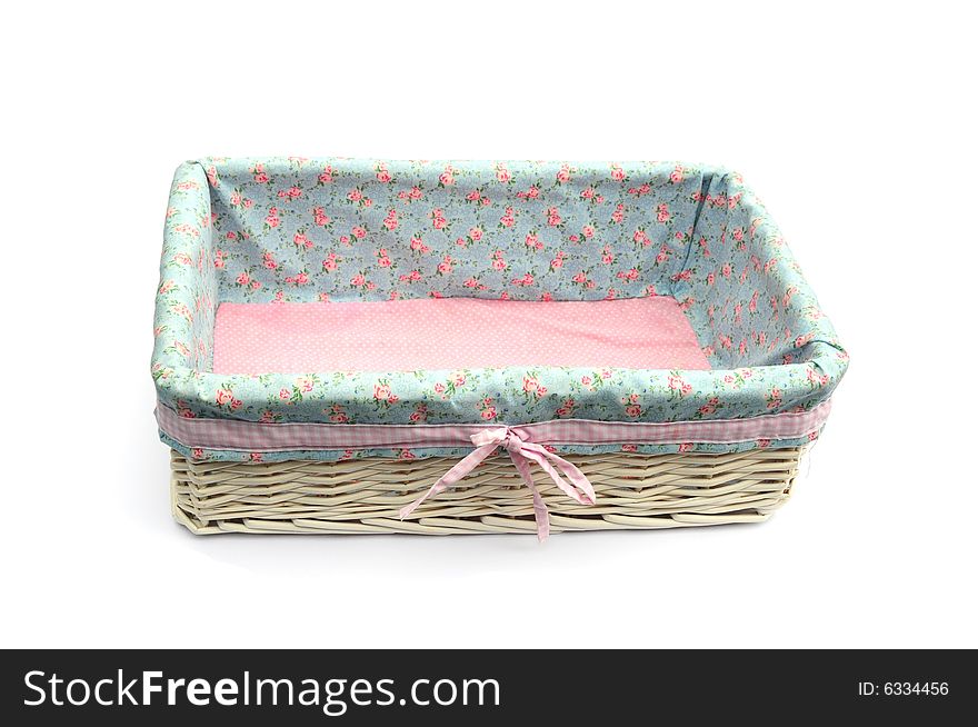 Prettily lined wicker basket on a white background. Prettily lined wicker basket on a white background