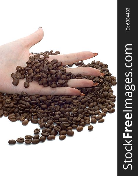 Female hand and coffee beans on white