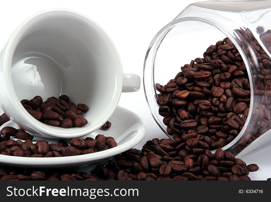 Cup and coffee beans and glass jar