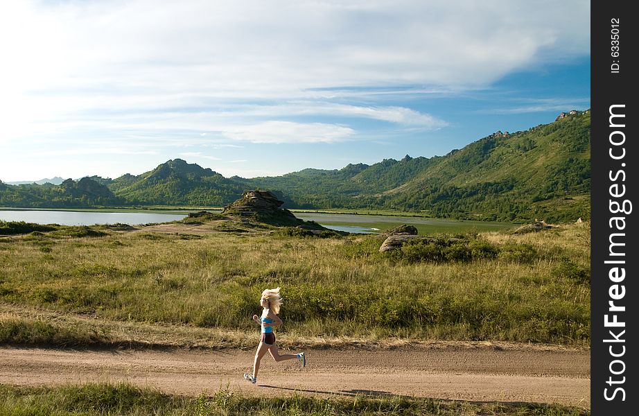 Young girl jogging in the countryside earlyin the morning. Young girl jogging in the countryside earlyin the morning