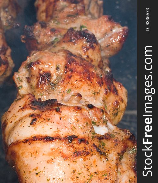 Shish kebab preparation on a brazier. Outdoor picnic. Close up.