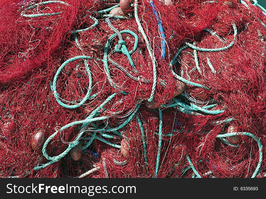 Red Fishing Net and Green Rope. Trawler Net Close-Up