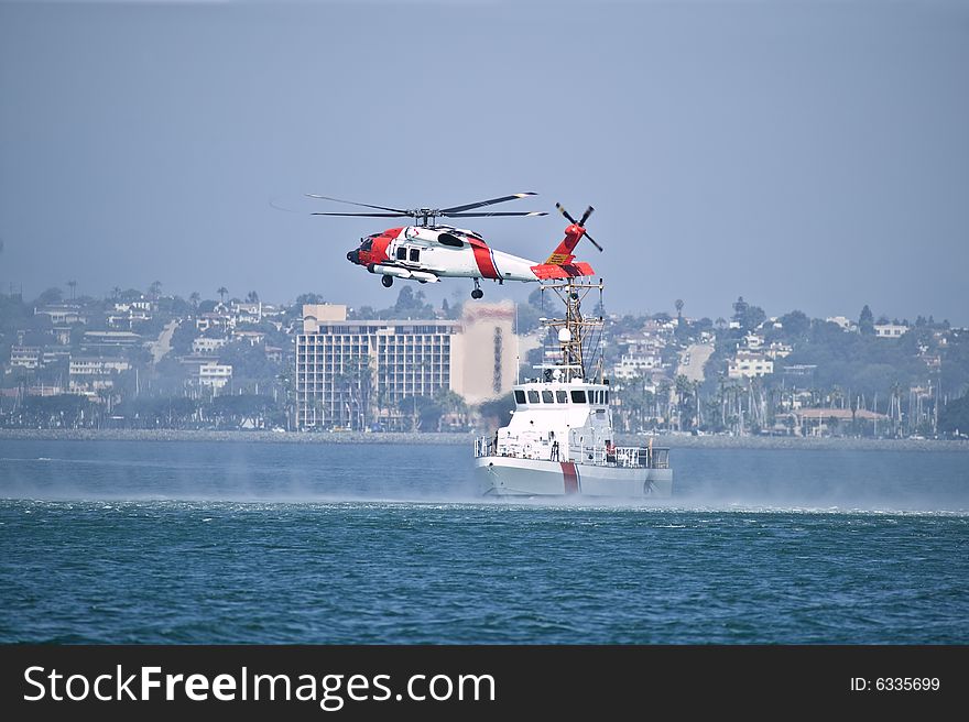 Coast Gaurd Jayhwak Helicopter hovering over search and rescue boat. Coast Gaurd Jayhwak Helicopter hovering over search and rescue boat