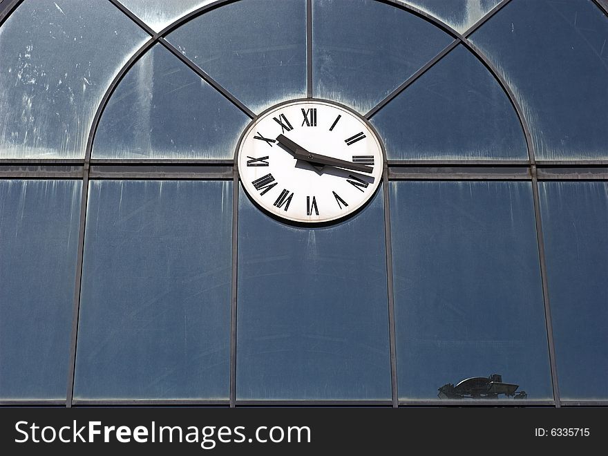 Clock on glass building wall.
Outdoors in the sun. Clock on glass building wall.
Outdoors in the sun.