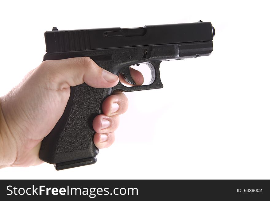 9mm handgun with a hand holding it on a white background. 9mm handgun with a hand holding it on a white background