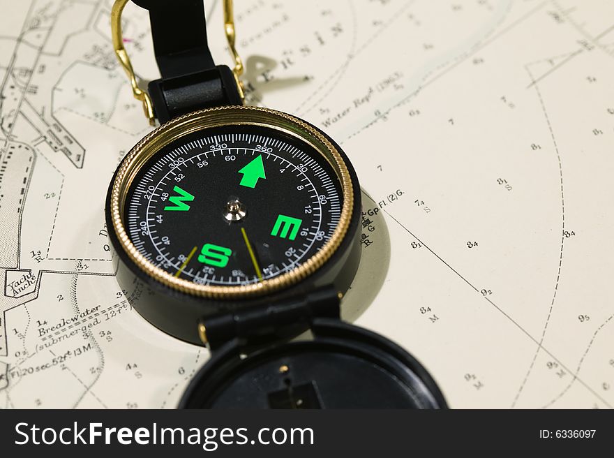 Navigational tools and compass on a nautical navigation map. Navigational tools and compass on a nautical navigation map