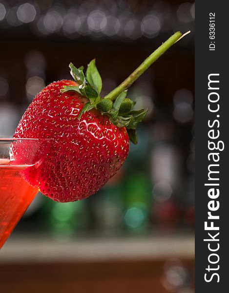 Strawberry on a Martini glass at a bar. Strawberry on a Martini glass at a bar.