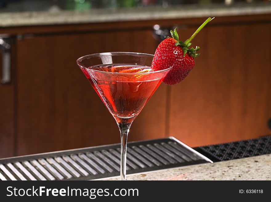 Strawberry on a Martini glass at a bar. Strawberry on a Martini glass at a bar.