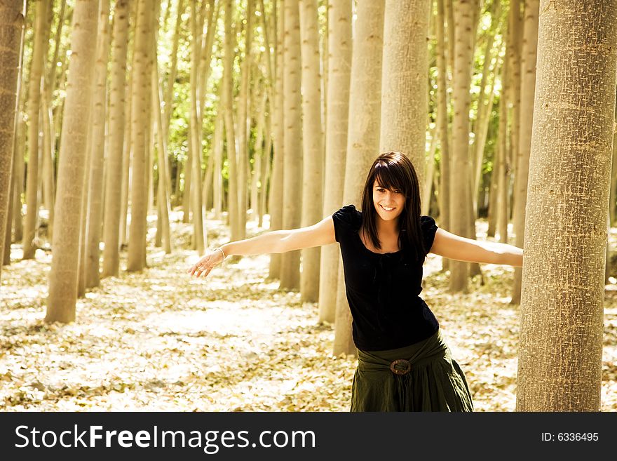Young beautiful woman playing in the woods. Young beautiful woman playing in the woods