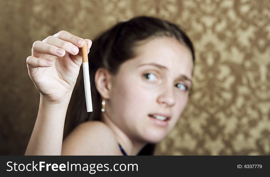Young girl with a cigarette showing disgust. Young girl with a cigarette showing disgust