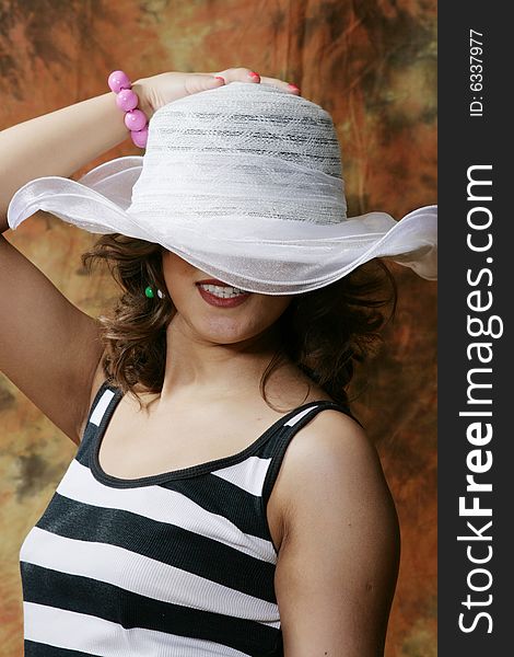 Portrait of the beautiful young woman in a hat