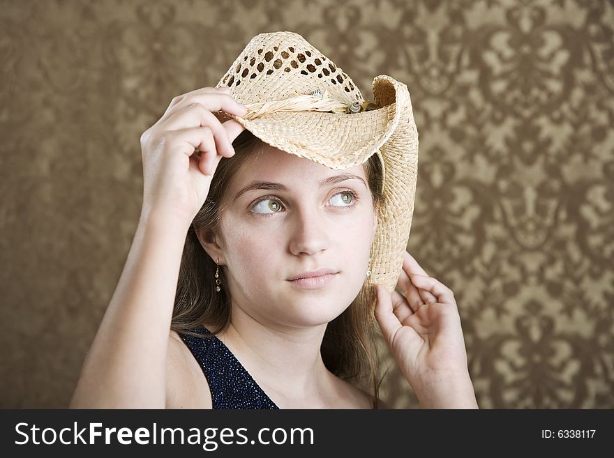 Confident Young Girl in a Blue Dress and Cowboy Hat. Confident Young Girl in a Blue Dress and Cowboy Hat