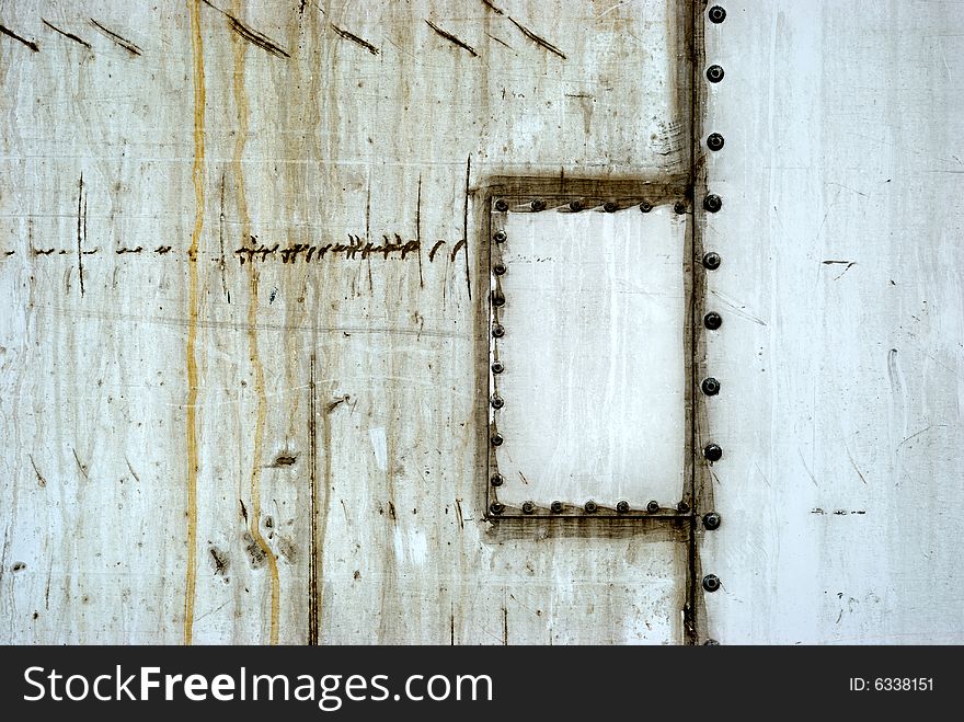 Old metal white door with rivets and patch