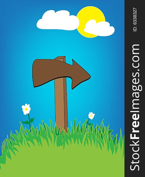 Wooden arrow, blue sky and green grass