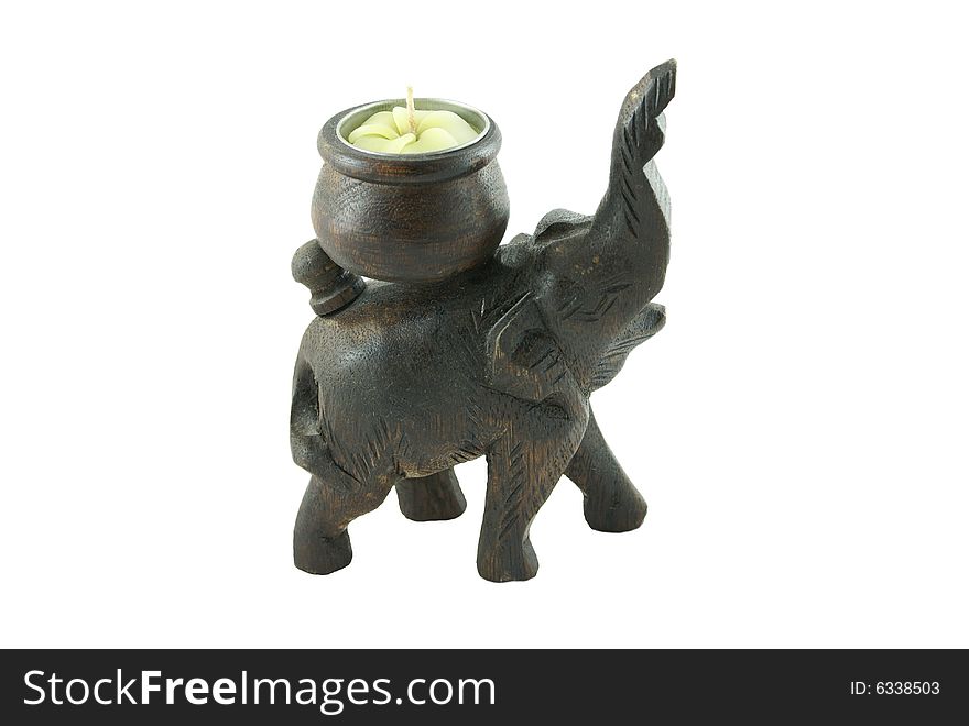 Wooden elephant with a candle on a white background