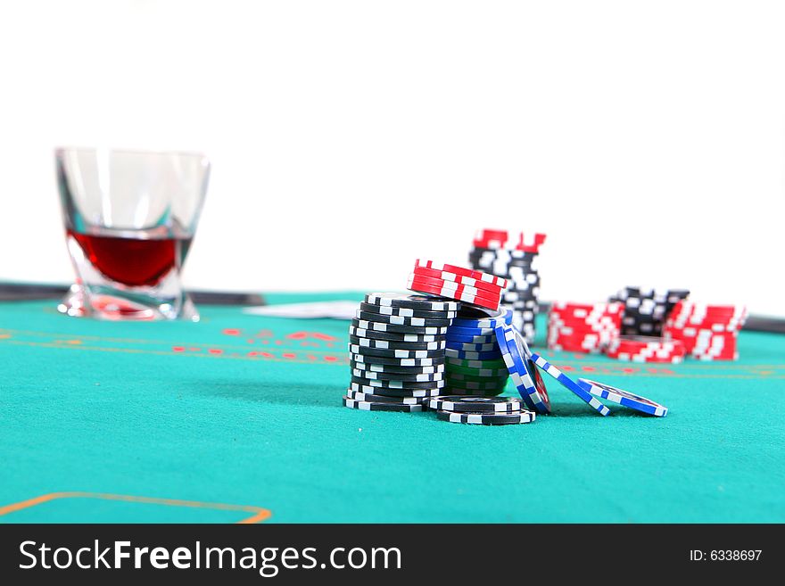 A poker table with chips a drink and cards. Isolated over white. A poker table with chips a drink and cards. Isolated over white.