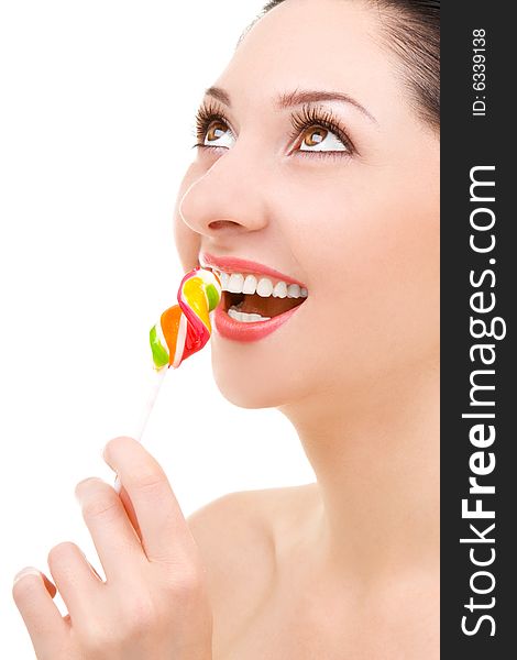 Pretty woman licking candy on white background