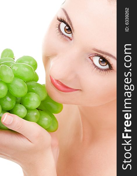 Pretty woman with green grape isolated on the white background