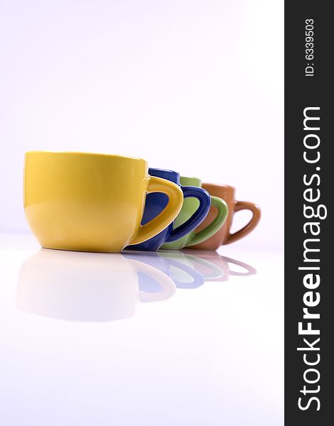 Colored coffee cups in line on white background. Colored coffee cups in line on white background