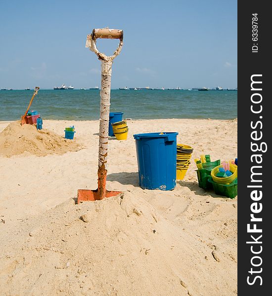 Sandcastle building tools and a mound of sand to start building castles