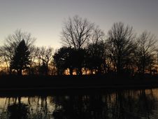 Trees Reflecting In Water Surface During Sunset In Winter. Royalty Free Stock Photography
