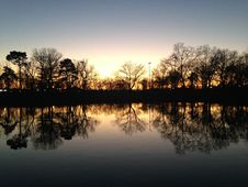 Trees Reflecting In Water Surface During Sunset In Winter. Royalty Free Stock Photos