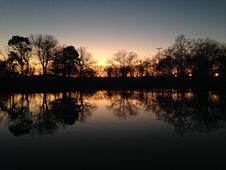 Trees Reflecting In Water Surface During Sunset In Winter. Royalty Free Stock Photos
