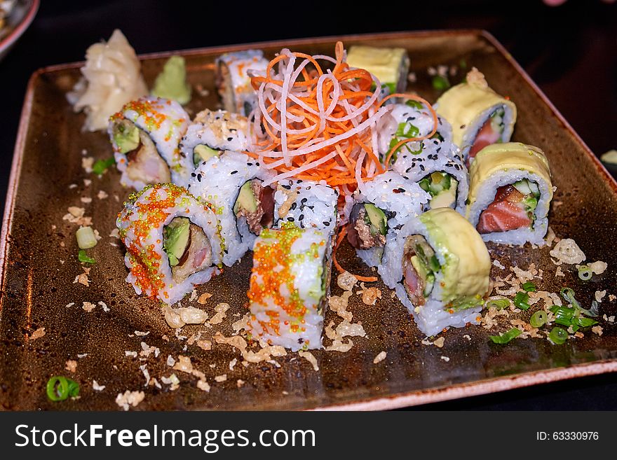 Sushi typical Japanese food served on a plate in a restaurant. Sushi typical Japanese food served on a plate in a restaurant