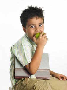 Asian Boy Eating A Green Apple Royalty Free Stock Image
