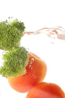 Tomato And Broccoli Vegetables Splash Stock Photo