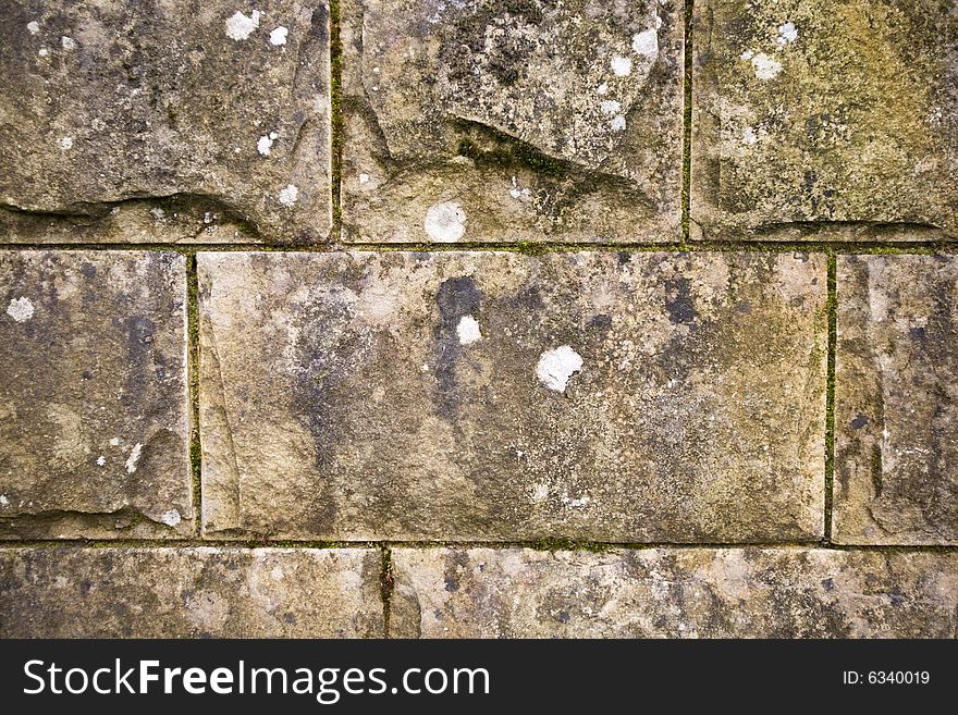 Stone wall background with lichen