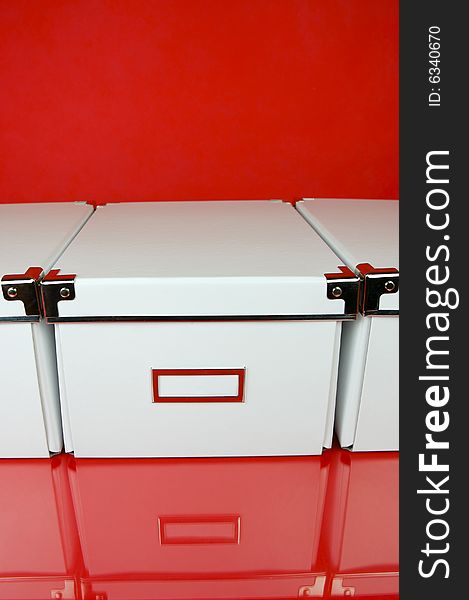 Storage boxes isolated against a red background