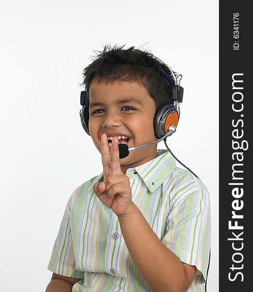 Asian boy with headphones victory sign. Asian boy with headphones victory sign