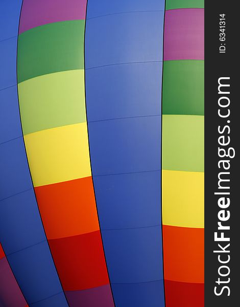 A colorful rainbow colored hot air balloon at the annual Kannapolis, North Carolina Hot Air Balloon festival. A colorful rainbow colored hot air balloon at the annual Kannapolis, North Carolina Hot Air Balloon festival