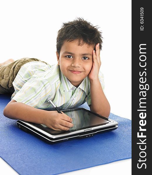 Asian boy of indian origin with a laptop. Asian boy of indian origin with a laptop