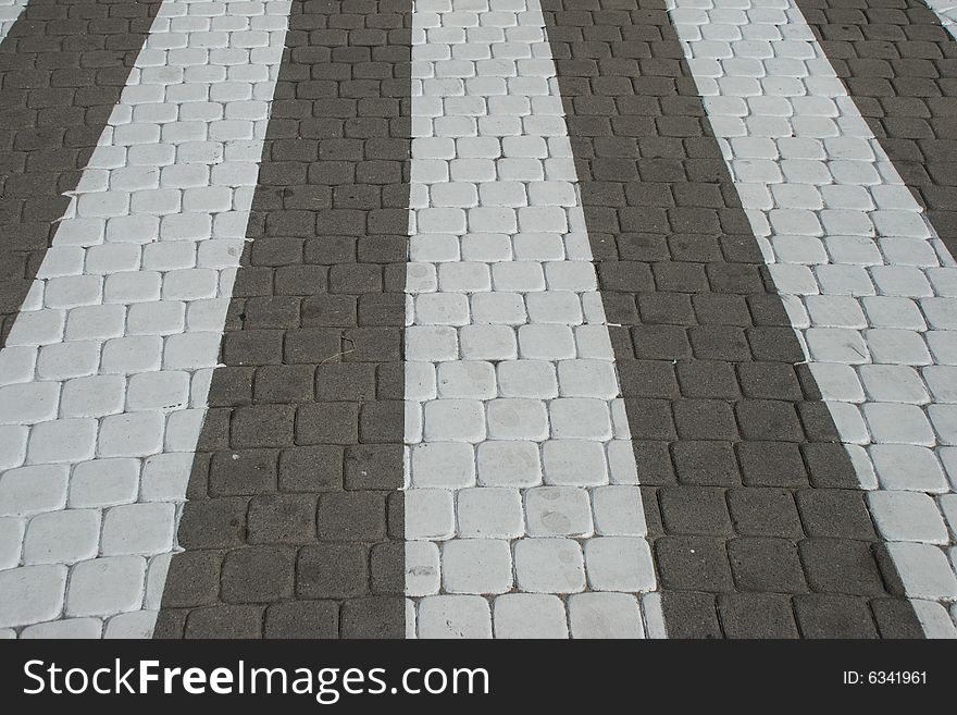 White walkway grids on the gray cobbles. White walkway grids on the gray cobbles