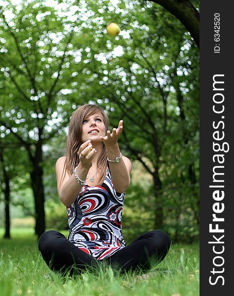 A picture of a girl throwing the apples. A picture of a girl throwing the apples