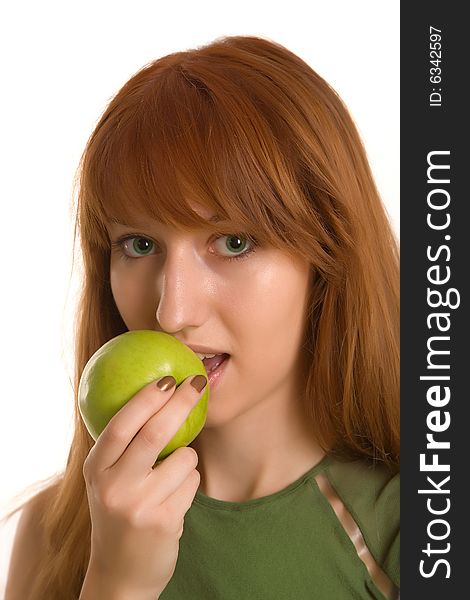 Red-haired girl eating green apple isolated on white background. Red-haired girl eating green apple isolated on white background