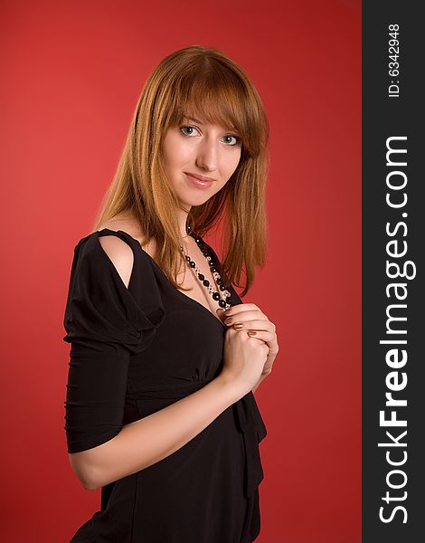 Sensual girl with necklace isolated on red background